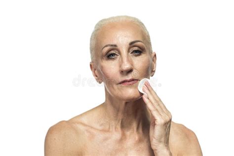 Senior Female Concepts Portrait Nude Of Senior Caucasian Woman Using Facial Cream Stock Photo