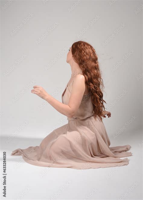 Full Length Portrait Of Beautiful Brunette Model Wearing A Creamy Pink Gown Dress Graceful
