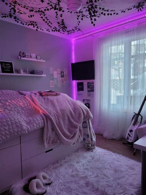 A Bedroom With Purple Lighting And White Fur Rugs On The Floor Along