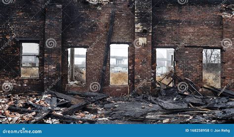 Old Brick Building Burned Out By Fire In City With Windows Looking Out