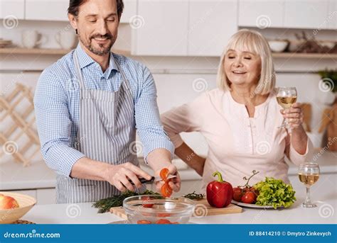 Mature Son Cooking Dinner For His Parent In The Kitchen Stock Photo Image Of Cook Mother