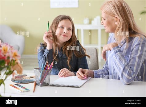 Mature Woman And Her Cute Granddaughter Drawing At Home Stock Photo Alamy