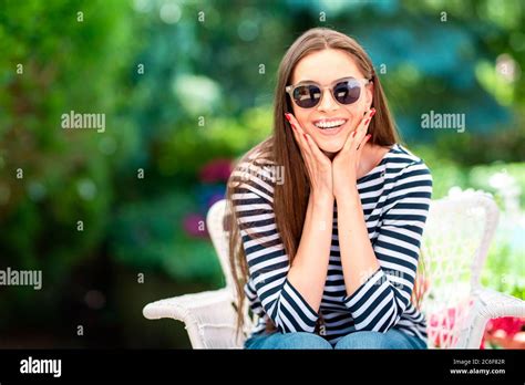 Portrait Of An Attractive Mid 20s Woman Gently Touching Her Face While