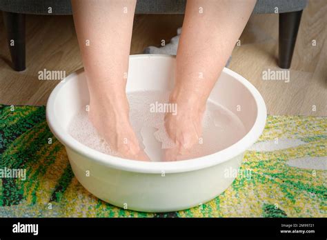 Foot Soaking Woman Put Hot Water For Her Feet Homemade Bath Soak For Dry Feet Skin Stock Photo
