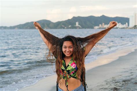 Cheerful Brunette Woman Touching Her Hair Smiling At The Camera Stock Photo Image Of Hair