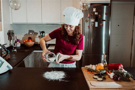 Premium Photo Woman Preparing Food On Kitchen Counter At Home