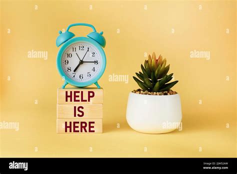 Help here and support symbol. Wooden blocks with the words Help here on ...