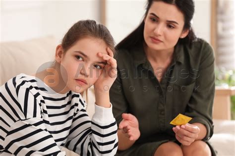 Mother Talking With Her Teenage Daughter About Contraception At Home Sex Education Concept