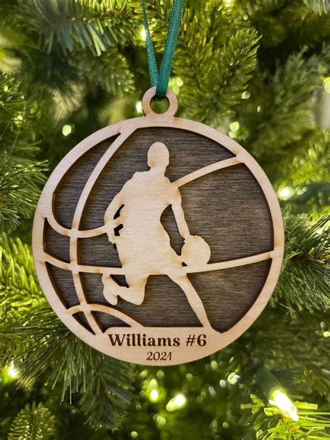 A Wooden Ornament Hanging From A Christmas Tree With A Basketball