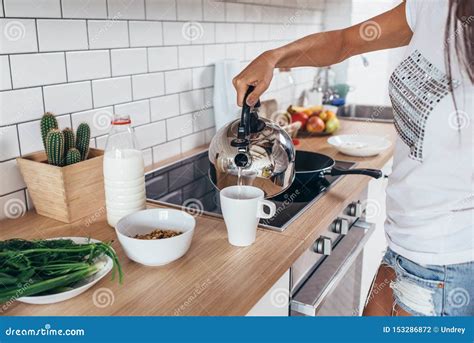 Woman Pouring Boiling Water Into A Cup From Kettle Stock Photo Image