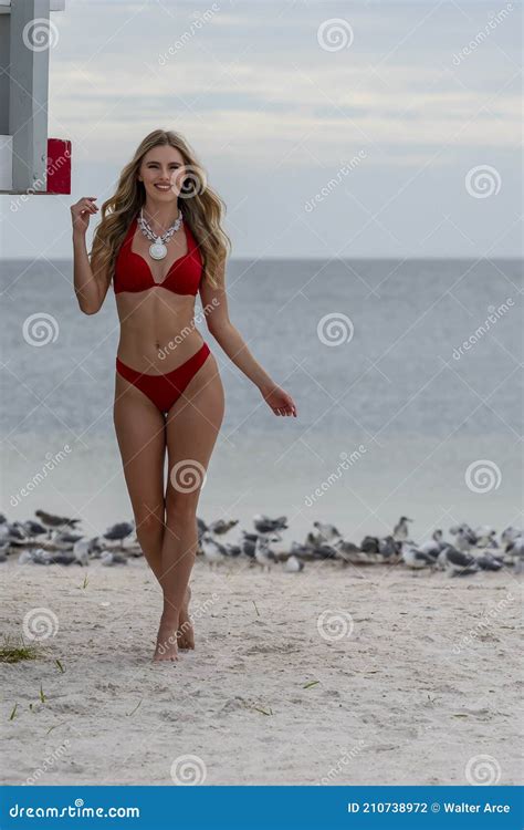 Lovely Blonde Bikini Model Posing Outdoors On A Caribbean Beach Near A Lifeguard Station Stock