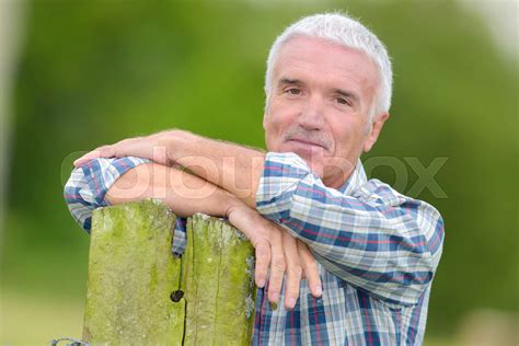 Mature Man Leaning On Post Stock Image Colourbox
