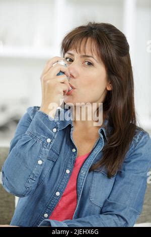 Pretty Brunette Woman Using Asthma Inhaler Stock Photo Alamy