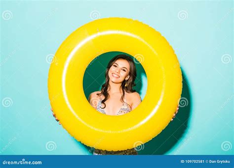 Woman In Bikini Inside Inflatable Ring Over Green Background Stock