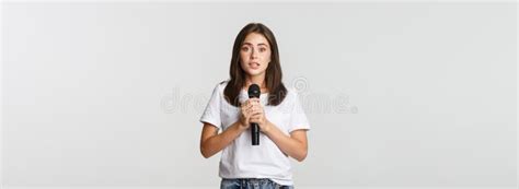 Shy Cute Brunette Girl Scared Of Singing In Public Standing With Microphone And Looking Nervous