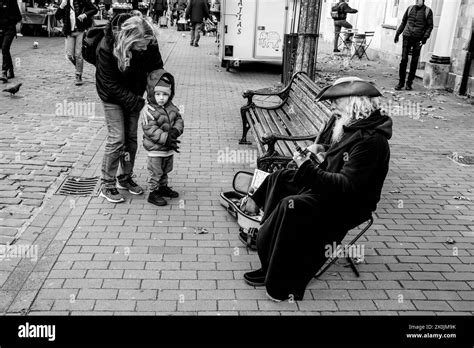A Child Nervously Watches A Pirate Street Entertainer In The High
