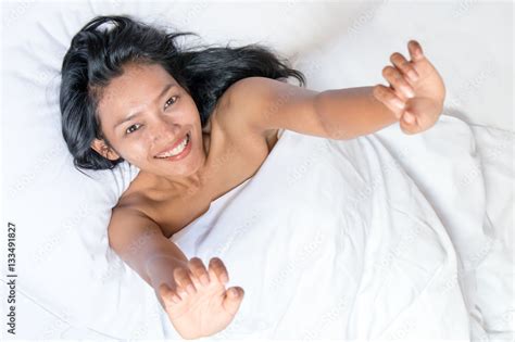 Asian Girl Stretches In Bed The Above Look Nude Woman Lying Under A White Blanket And