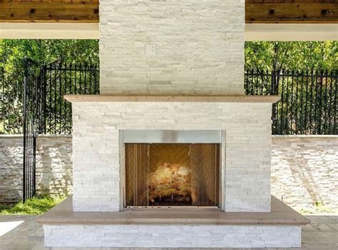 An Outdoor Fireplace Is Shown In The Middle Of A Patio