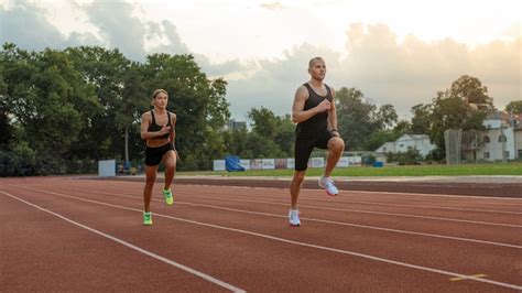 Premium Photo Man And Woman Running On Track Side View