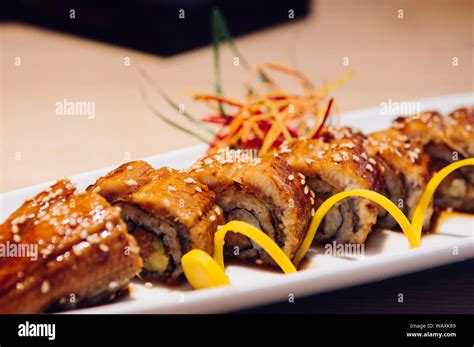 Beautiful Pieces Of Japanese Grilled Unagi Maki Roll On White Plate