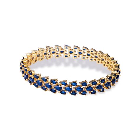 BRACELET JONC À TROIS RANGS OR ET PIERRES BLEUES