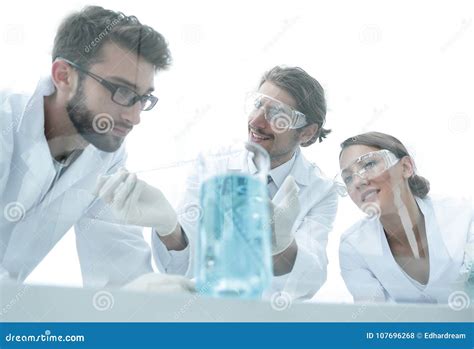 Group Of Scientists Working On An Experiment At The Laboratory Stock