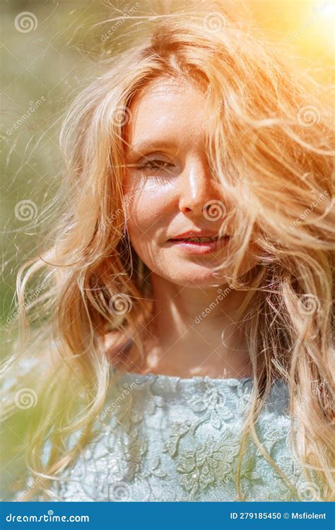 Blond Garden Portrait Of A Blonde In The Park Happy Woman With Long Blond Hair In A Blue Dress