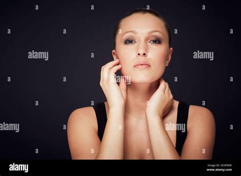 Checking Her Skin Studio Portrait Of A Beautiful Young Woman Touching