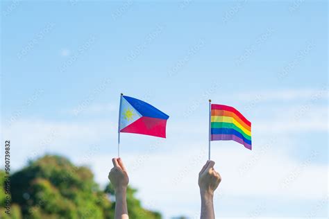Hands Showing LGBTQ Rainbow And Philippines Flag On Nature Background Support Lesbian Gay