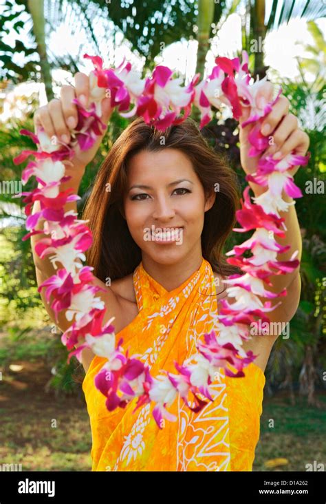 Hawaii Oahu Local Girl Wearing A Yellow Pareo Holds Out A Lei