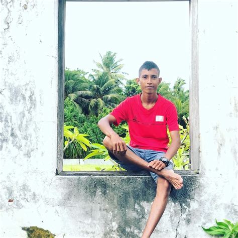 Premium Photo Portrait Of Man Sitting Against Plants