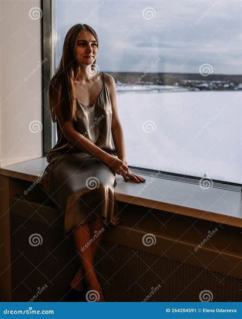 Young Woman Resting at Hotel, Sitting on the Window Sill Enjoying