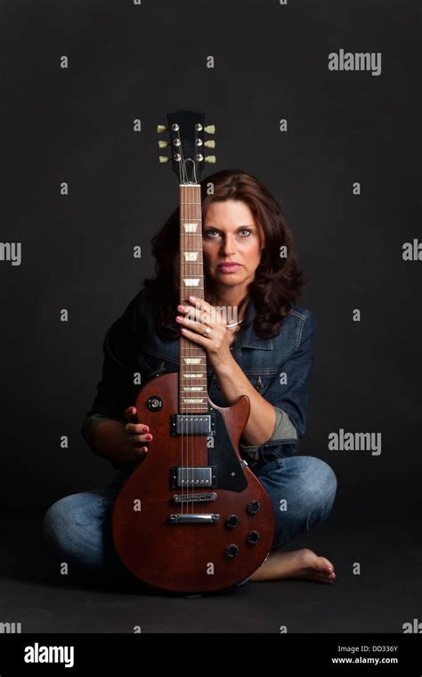 Brunette Woman On Black With A Guitar Stock Photo Alamy