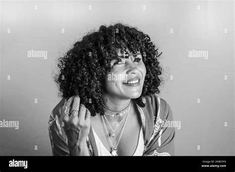 Portrait Of Smiling Beautiful Curly Hair Model Against Light Background Mature Woman Self