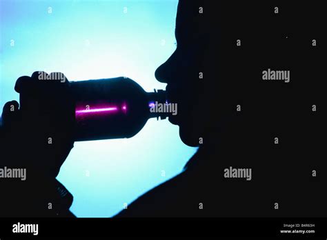 A Woman Drinking Out Of A Bottle Stock Photo Alamy
