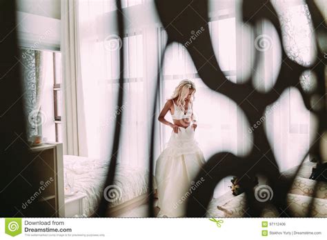 Sexual Bride In White Lingerie Is Putting On Her White Wedding Dress Stock Photo Image Of