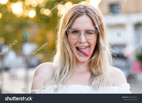 Funny Blonde Woman Showing Long Tongue Stock Photo 1633610701