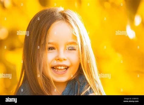 Little Girl On Yellow Leaves Foliage Background Autumn Portrait Of