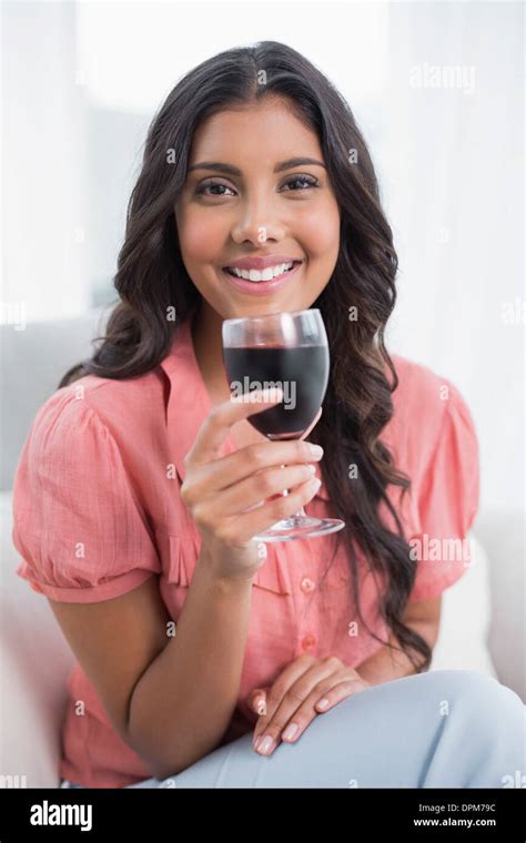 Happy Cute Brunette Sitting On Couch Holding Wine Glass Stock Photo Alamy