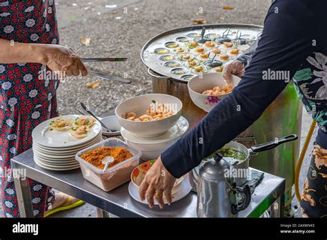 Vietnamese Hawker Making Crispy Shrimp Pancake At Street Vendor Stock