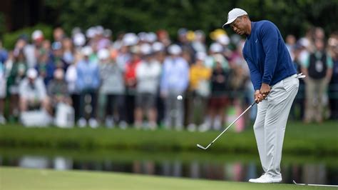 Masters champion Tiger Woods chips to the No. 15 green during Monday's