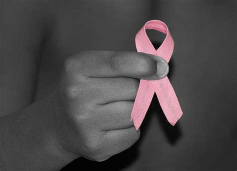 Premium Photo Hand Holding Pink Breast Cancer Ribbon