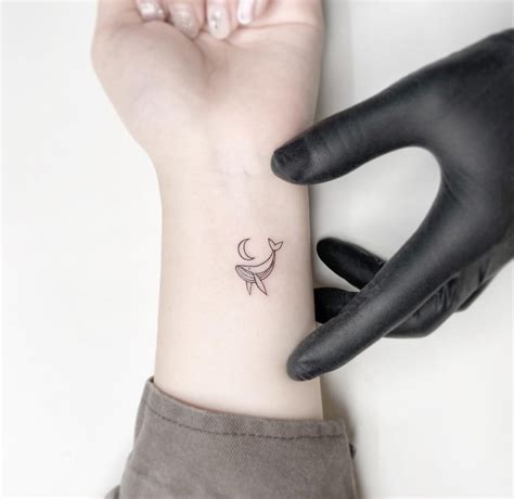 Minimalist Whale Tattoo On The Wrist TheFab20s