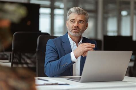 Premium Photo Busy Mature Businessman Workingon Laptop While Sitting In Modern Coworking