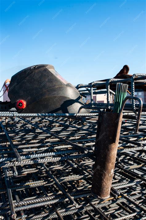Premium Photo | The welders mask lies on a metal armature