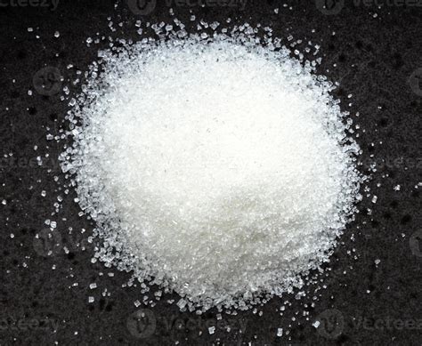 pile of white refined beet sugar close up on black 11394244 Stock Photo