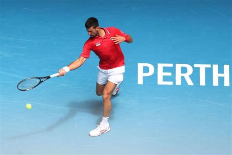 A Man Swinging A Tennis Racquet At A Ball On A Blue Tennis Court