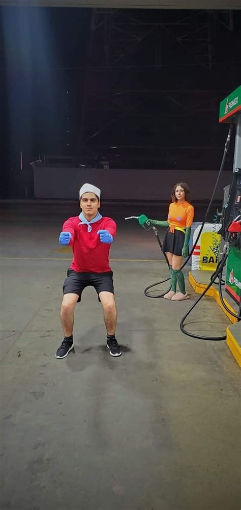 Two People Are Doing Exercises In Front Of A Gas Station Pumper With