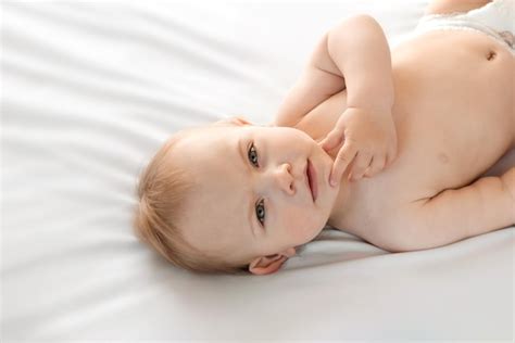 Premium Photo Happy Naked Baby In Diaper Lying On His Back White
