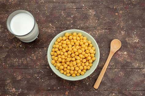 Free Photo Top View Yellow Cereals Inside Plate With Fresh Cold Milk